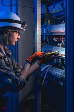 Electrician testing electrical panel with voltage tester. Industrial mainte.. Stock Photos