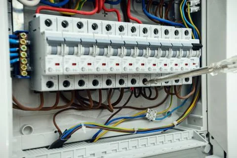 Electrician testing the electrical shield. Electrical switchboard with automats Stock Photos