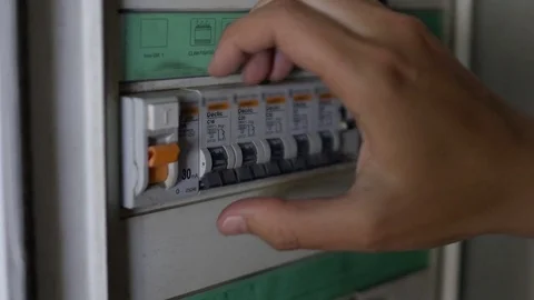 Electrician turning on automatic light switches for sports stadium before match Stock Footage 75947749