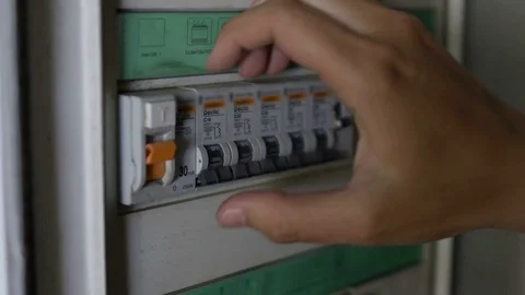Electrician turning on automatic light switches for sports stadium before match Stock Footage 75948249