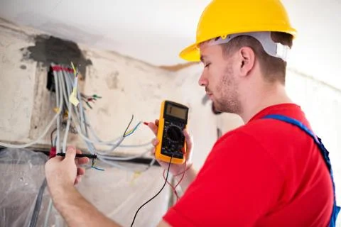 Electrician with unimer testing cable connectivity Stock Photos