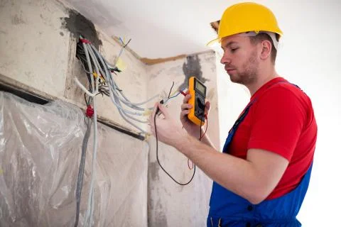 Electrician with unimer testing cable connectivity Stock Photos