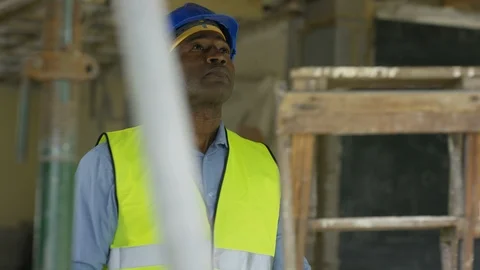 Electrician using electric drill to drill hole in pipe at construction site Stock Footage 108197689