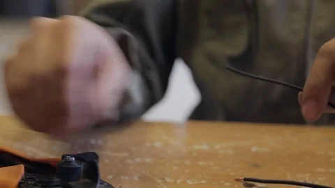 Electrician using a special instrument cleans the black wire Stock Footage 74229600