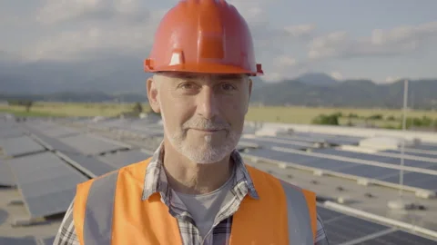 Electrician using tablet standing at rooftop solar panels array portrait Stock Footage 278468654