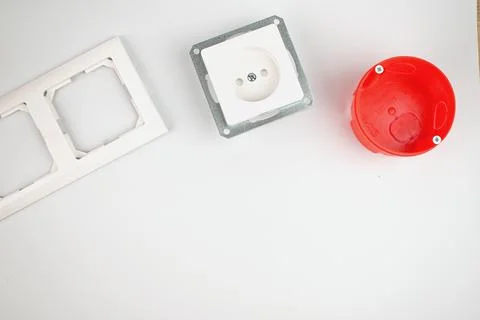Electrician. White socket, socket cover and red socket box. Renovation concep Stock Photos