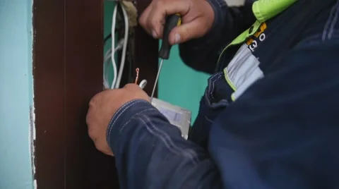 Electrician wiring up a switch indoor, close up Stock Footage