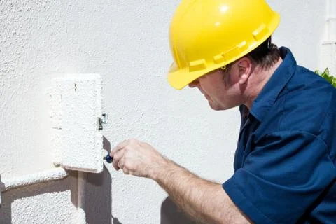 Electrician Working in Electrical Box Stock Photos
