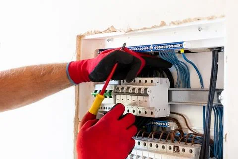 Electrician Working in Electrical Panel Stock Photos