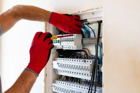 Electrician Working in Electrical Panel Stock Photos