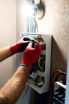 Electrician Working in Electrical Panel Stock Photos