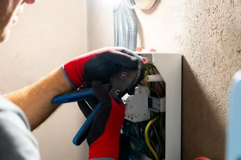 Electrician Working in Electrical Panel Foto stock