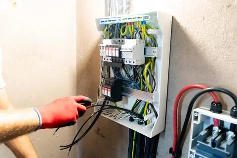 Electrician Working in Electrical Panel Foto stock