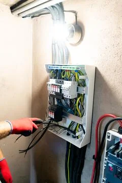 Electrician Working in Electrical Panel Stock Photos