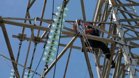 Electrician working on high-voltage power support Stock Footage 56589352
