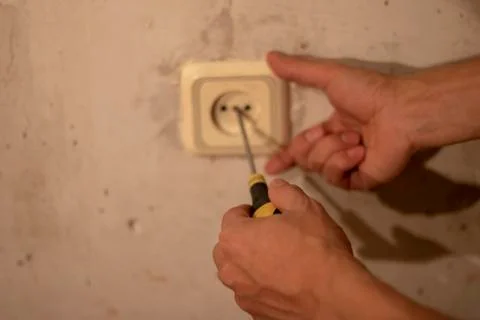 Electrician working at plug socket in a kitchen,horizontal Stock Photos
