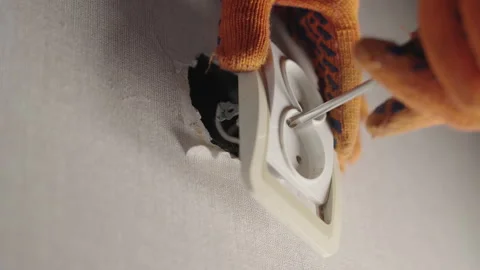 Electrician with Wrong Screwdriver Trying to Fix Loose Wall Socket, House Repair Video stock 300223247