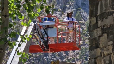 Electricians on Aerial Work Platform Going Up by Building, Close Up Video stock 315262336