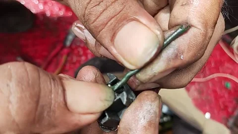 Electrician's hand inspecting damaged cable socket Stock Footage 305810521