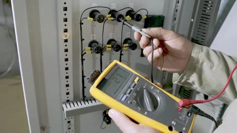 Electricians hands testing current electric in control panel Video stock 156065316