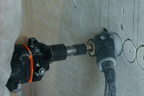 Electricians skillfully installing electrical wiring during construction work Stock Photos