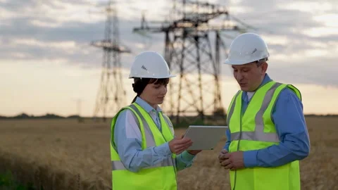 Electricians with tablet approve innovative technology of power generation plant Stock Footage 257481000