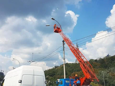 Electricians using an electrical installation tower repair street lighting .. Stock Photos