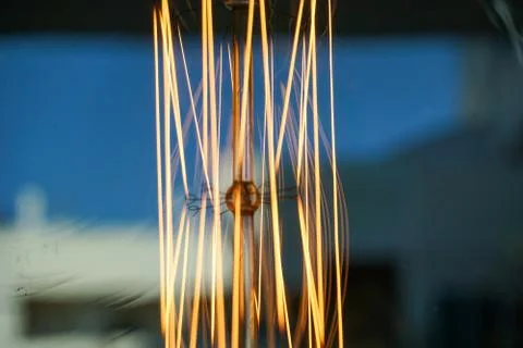 Electricity current inside a retro crystal clear light bulb. Stock Photos