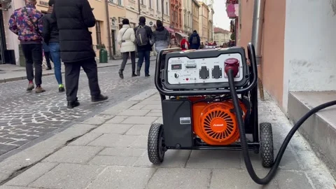 A electricity generator work outside the cafe.. Video stock 228730916