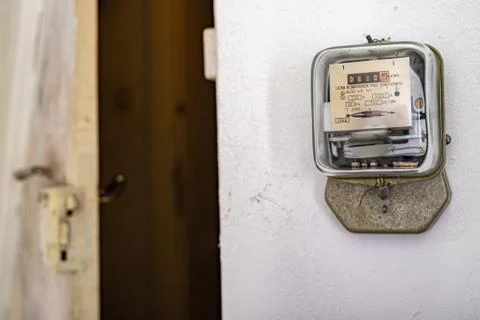 Electricity meter on a white wall. A device for measuring the consumption of  Stock Photos