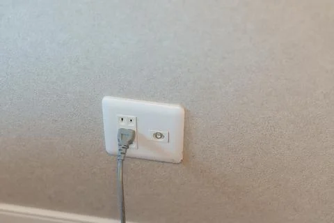 Electricity plug device and cable tv socket on wall at home. power supply, .. Stock Photos