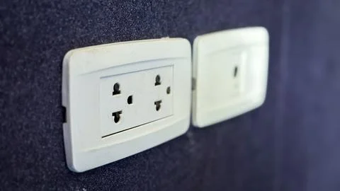 Electricity plug on the wall background Stock Photos