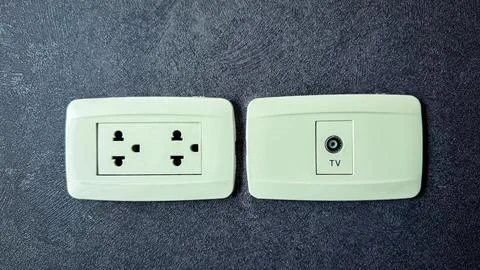 Electricity plug on the wall background Photos