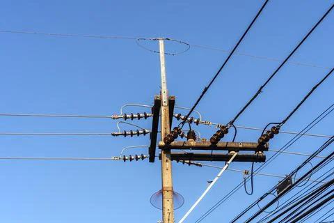 Electricity pole against blue sky clouds, Transmission line of electricity to Stock Photos