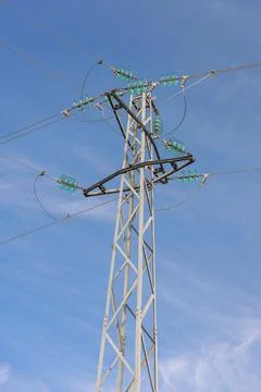 Electricity pole seen from below with blue sky. Stock Photos