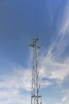 Electricity pole seen from below with blue sky. Stock Photos