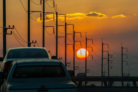 Electricity post in front of sunset background Stock Photos