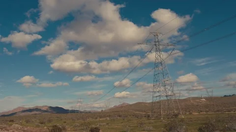 Electricity power lines running through desert landscape with clouds Stock-Footage 346005295