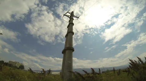 Electricity pylon against blue sky - time lapse Stock Footage