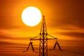 The electricity pylon with wire and hude sun background it Photo
