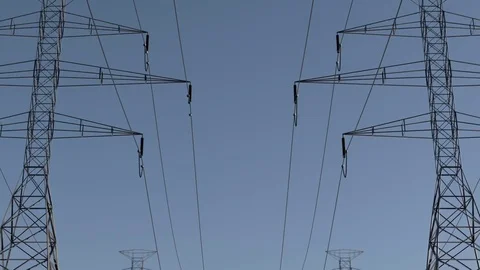 Electricity pylons. Moving along two row of pylons. electric high voltage pylon 库存影片 75337214