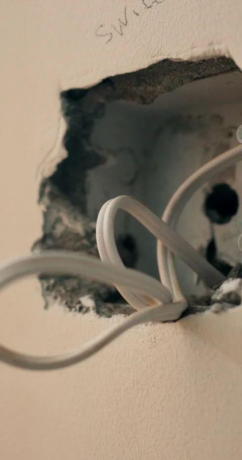Electricity, remodeling and cable with hole in wall for home renovation, power Stock Footage 340890541