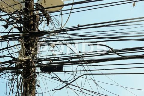 Electricity spaghetti in Asian town Stock Photos