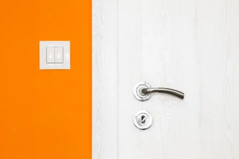 Electricity switch in a bright orange wall Stock Photos