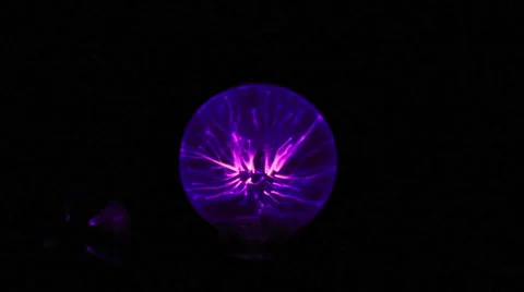 Electricity from a tesla coil based violet wand jumps to a small light bulb 1 Stock Footage 46942001