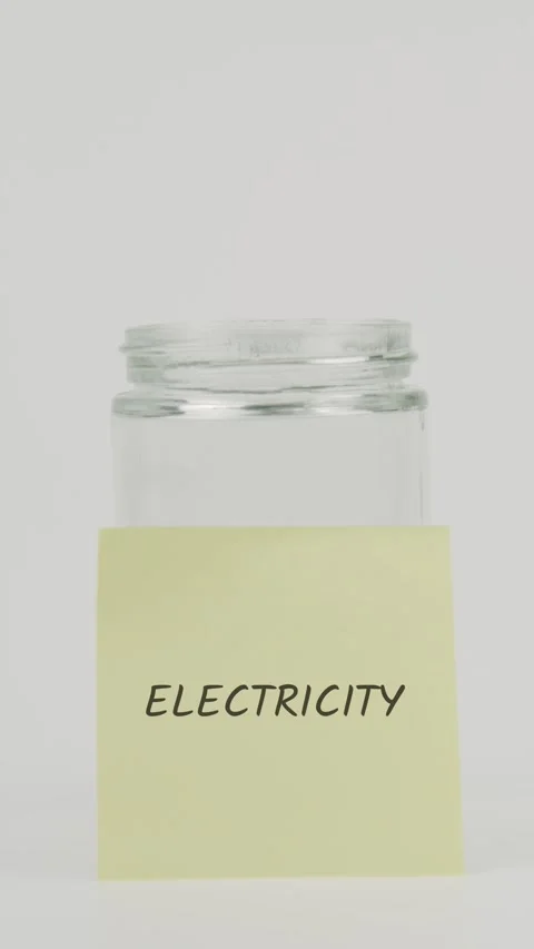 Electricity text or word on yellow sticky note attached to glass jar Stock Footage 311724625