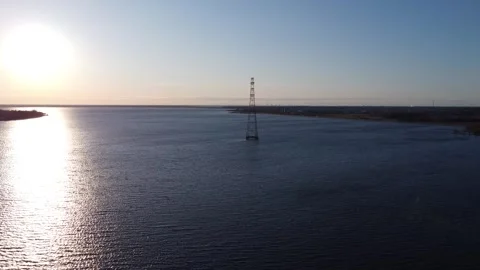 Electricity Tower in the middle of a River, stunning Sunset Drone 4K Video stock 306305217