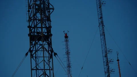 An electricity tower with a red light bulb. Telecommunication tower  Stock Footage 282050893