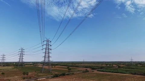 Electricity transmission tower distributing power across green countryside Stock Footage 340814075