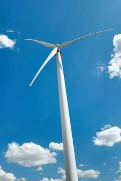 Electricity wind generator on bright cloudy sky background - wind energy and  Stock Photos
